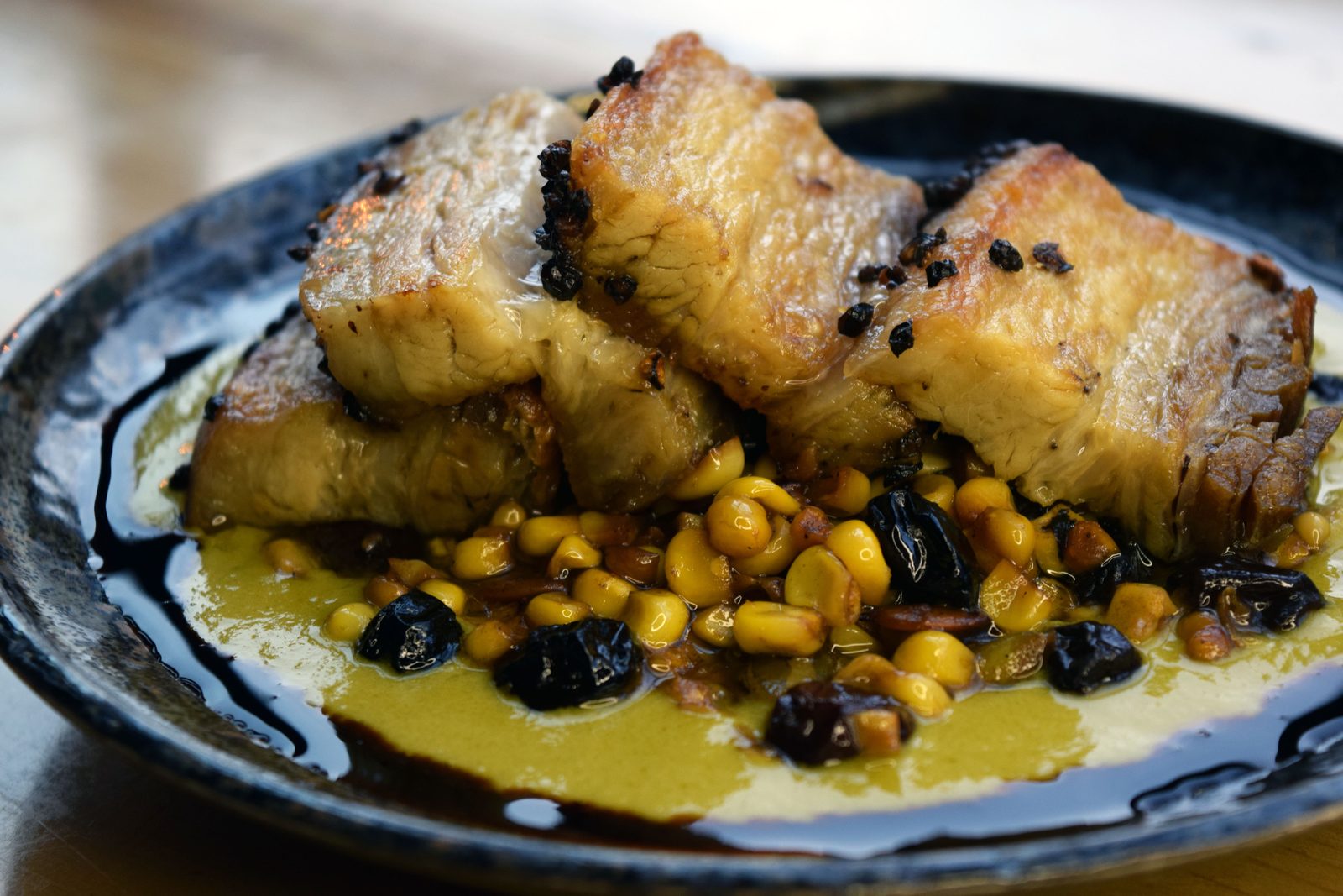 Pork belly with onion cream and white bean succotash
